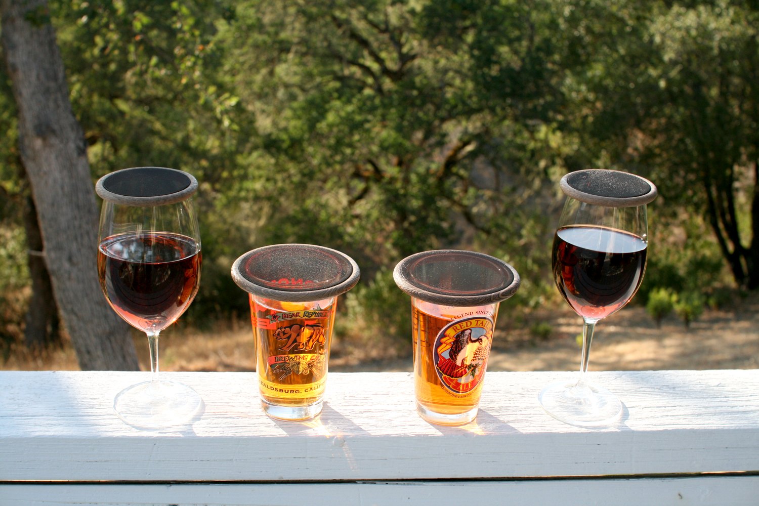 Fly Filters mesh drink covers on wine glasses and beer cups outdoors